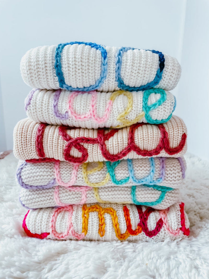 Hand-embroidered baby name sweater